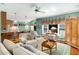 Inviting living room with comfortable sofas, a ceiling fan, and a view of the open-concept kitchen and dining area at 3953 Lorien Nw Way, Kennesaw, GA 30152