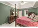 Spacious main bedroom featuring a four-poster bed, tray ceiling, and elegant furnishings at 3953 Lorien Nw Way, Kennesaw, GA 30152