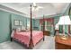 Spacious main bedroom with a four poster bed, tray ceiling, and mint green walls at 3953 Lorien Nw Way, Kennesaw, GA 30152