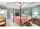 Comfortable main bedroom featuring a four-poster bed, neutral carpet, and large windows at 3953 Lorien Nw Way, Kennesaw, GA 30152