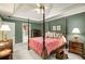 Main bedroom with a tray ceiling, four-poster bed, and ensuite bathroom at 3953 Lorien Nw Way, Kennesaw, GA 30152