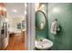 Stylish powder room featuring a decorative mirror and custom paint, conveniently located near the kitchen at 3953 Lorien Nw Way, Kennesaw, GA 30152