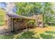 Backyard view featuring a two-story home with a brick exterior, deck, and fenced yard at 4016 Nations Dr, Douglasville, GA 30135