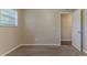 Bedroom with tan walls, trim, new carpet, and an open doorway at 4016 Nations Dr, Douglasville, GA 30135