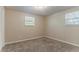 Cozy bedroom with neutral walls, trim, new carpet, and two windows letting in light at 4016 Nations Dr, Douglasville, GA 30135