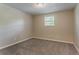 Neutral bedroom with carpet, fresh paint, and a window letting in natural light at 4016 Nations Dr, Douglasville, GA 30135