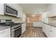 Modern kitchen with stainless steel oven and microwave, open to living area at 4016 Nations Dr, Douglasville, GA 30135