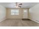 Bright living room with large window, ceiling fan, and neutral carpet flooring at 4016 Nations Dr, Douglasville, GA 30135