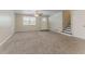 Spacious living room with plush carpeting, ceiling fan, and ample natural light at 4016 Nations Dr, Douglasville, GA 30135