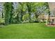 Large, meticulously maintained backyard offers ample space and a charming deck at 1386 Pineglen Dr, Riverdale, GA 30296