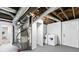 A functional basement area featuring washer, dryer, and plenty of storage space at 1386 Pineglen Dr, Riverdale, GA 30296