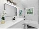 Modern bathroom with sleek vanity, new lighting fixtures, and a tub with shower at 1386 Pineglen Dr, Riverdale, GA 30296
