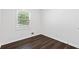 Bedroom showcasing hardwood floors, a window bringing in natural light, and neutral walls at 1386 Pineglen Dr, Riverdale, GA 30296
