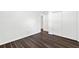 Bedroom showcasing hardwood floors, white walls, and a large closet with sliding doors at 1386 Pineglen Dr, Riverdale, GA 30296