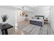 Modern bedroom boasts a gray upholstered bed, neutral decor, and light wood flooring at 1386 Pineglen Dr, Riverdale, GA 30296