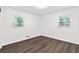 Bedroom featuring hardwood floors, two windows, and neutral walls at 1386 Pineglen Dr, Riverdale, GA 30296