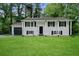 Charming two-story home featuring a well-maintained lawn and attached garage at 1386 Pineglen Dr, Riverdale, GA 30296