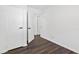 Bright hallway showing dark wood floors, white walls, and white doors with black hardware at 1386 Pineglen Dr, Riverdale, GA 30296