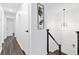 Hallway showing modern decor, hardwood floors, and neutral paint with black hardware at 1386 Pineglen Dr, Riverdale, GA 30296