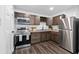 Well-equipped kitchen features stainless steel appliances and dark wood cabinets at 1386 Pineglen Dr, Riverdale, GA 30296