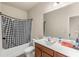 Bathroom featuring a shower with checkered curtain, toilet, sink and mirror at 1749 Charcoal Ives Rd, Lawrenceville, GA 30045