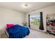 Bedroom featuring a window, carpet, and a shelf at 1749 Charcoal Ives Rd, Lawrenceville, GA 30045
