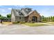 Beautiful community clubhouse with stone accents, manicured landscaping and convenient parking at 1749 Charcoal Ives Rd, Lawrenceville, GA 30045