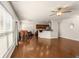 Bright and airy living room showcasing hardwood floors and large windows, seamlessly connected to dining area at 1749 Charcoal Ives Rd, Lawrenceville, GA 30045