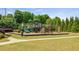 A fun community playground with slides and climbing structures, surrounded by lush greenery at 1749 Charcoal Ives Rd, Lawrenceville, GA 30045