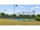 Well-maintained community tennis courts enclosed by a fence and lit for evening play at 1749 Charcoal Ives Rd, Lawrenceville, GA 30045