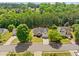 A high aerial view of a charming house nestled in a lush green landscape neighborhood with mature trees at 1835 Patrick Mill, Buford, GA 30518