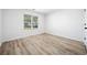 Bedroom features stylish light wood flooring, a window to let in natural light, and neutral white walls at 1835 Patrick Mill, Buford, GA 30518