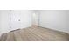 Bedroom featuring stylish light wood flooring, neutral white walls, and two door entryways at 1835 Patrick Mill, Buford, GA 30518