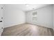 Bright bedroom featuring stylish light wood flooring, a window, and neutral white walls at 1835 Patrick Mill, Buford, GA 30518
