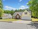 Charming home featuring a well-manicured lawn, brick accents, and a two-car garage with a lovely blue sky overhead at 1835 Patrick Mill, Buford, GA 30518