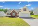 Charming home featuring a well-manicured lawn, brick accents, and a two-car garage with a lovely blue sky overhead at 1835 Patrick Mill, Buford, GA 30518