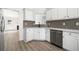 Well-lit kitchen featuring white cabinets, modern appliances, stone countertops, and a decorative tile backsplash at 1835 Patrick Mill, Buford, GA 30518