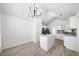 Bright kitchen with white cabinets, a kitchen island, new lighting and stainless steel appliances perfect for cooking at 1835 Patrick Mill, Buford, GA 30518