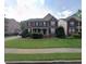 Traditional two-story home featuring a well-manicured lawn and mature landscaping at 2667 Hampton Park Dr, Marietta, GA 30062