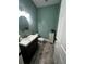 Cozy half bathroom with a vanity, toilet, mirror, and light-blue paint at 2667 Hampton Park Dr, Marietta, GA 30062
