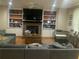 Comfortable living room with a brick fireplace, built-in bookshelves, and plush seating at 2667 Hampton Park Dr, Marietta, GA 30062