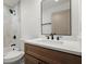 Modern bathroom with granite vanity, black faucet, and walk-in shower with gray tile at 32 Wadley Nw St, Atlanta, GA 30314