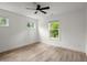 Bright bedroom features hardwood floors, three windows, and a modern ceiling fan at 32 Wadley Nw St, Atlanta, GA 30314