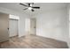 Modern bedroom with neutral paint, sliding closet door, light floors, and ceiling fan at 32 Wadley Nw St, Atlanta, GA 30314