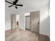 Open bedroom with sliding closet door, light floors, neutral paint, and modern ceiling fan at 32 Wadley Nw St, Atlanta, GA 30314