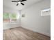 This bedroom features luxury vinyl flooring, three windows, and white trim throughout at 32 Wadley Nw St, Atlanta, GA 30314