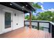 Wide deck with wooden floors, black railings, and exterior door leading into house at 32 Wadley Nw St, Atlanta, GA 30314