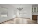 Open dining area featuring modern light fixture, lots of windows, and modern wood flooring at 32 Wadley Nw St, Atlanta, GA 30314