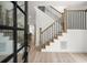 Elegant entryway featuring wood and metal stair railings and modern wood flooring at 32 Wadley Nw St, Atlanta, GA 30314