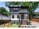 Contemporary two-story home with a balcony, landscaped yard, and inviting staircase at 32 Wadley Nw St, Atlanta, GA 30314
